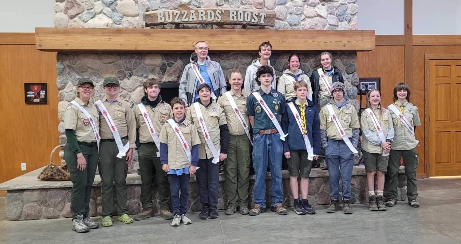 Members wearing sashes line up for a picture inside OA Lodge 40