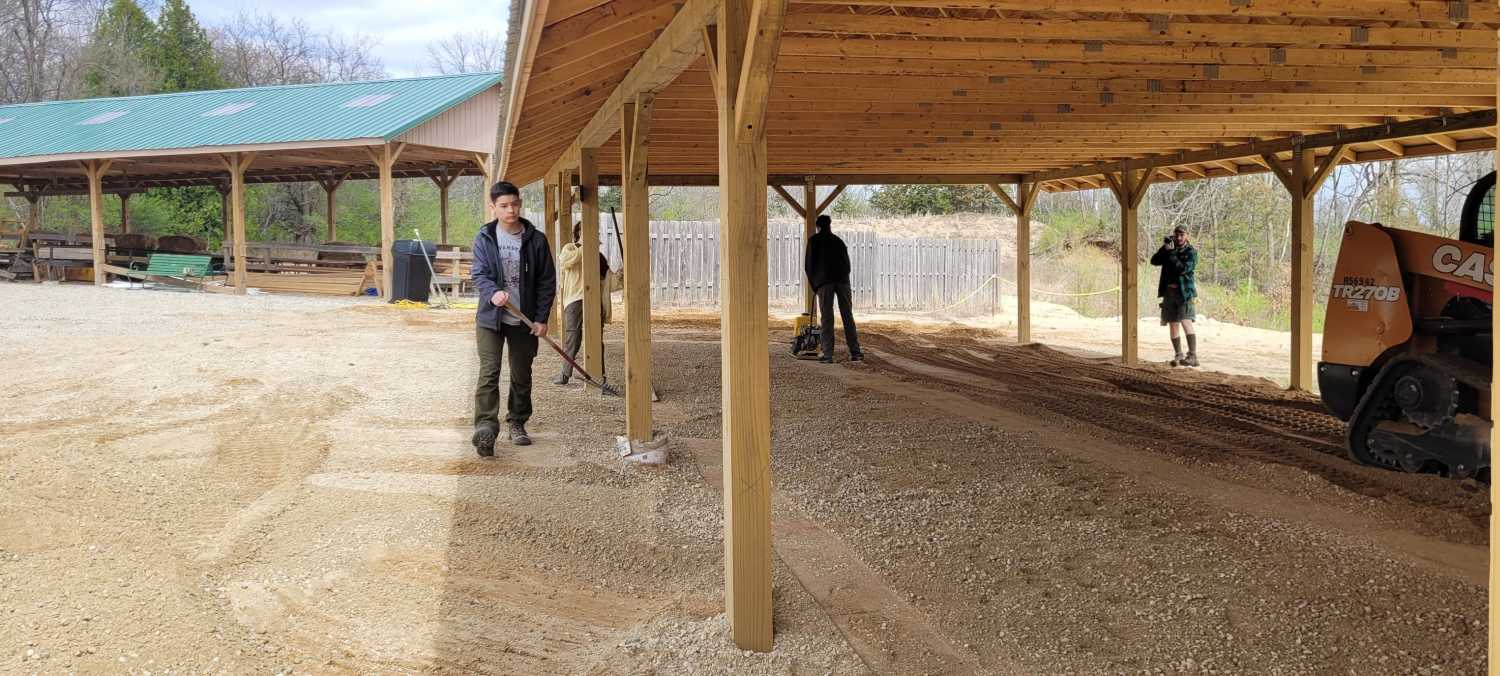 An OA Lodge 40 service project in-action shot shows scouts doing cleanup work